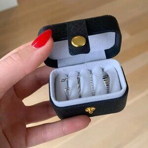 The Viaggio Black leather travel ring case with gold hardware